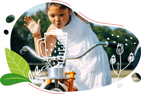 photo d'une petite fille en robe blanche en train de pédaler un smoothie sur son vélo